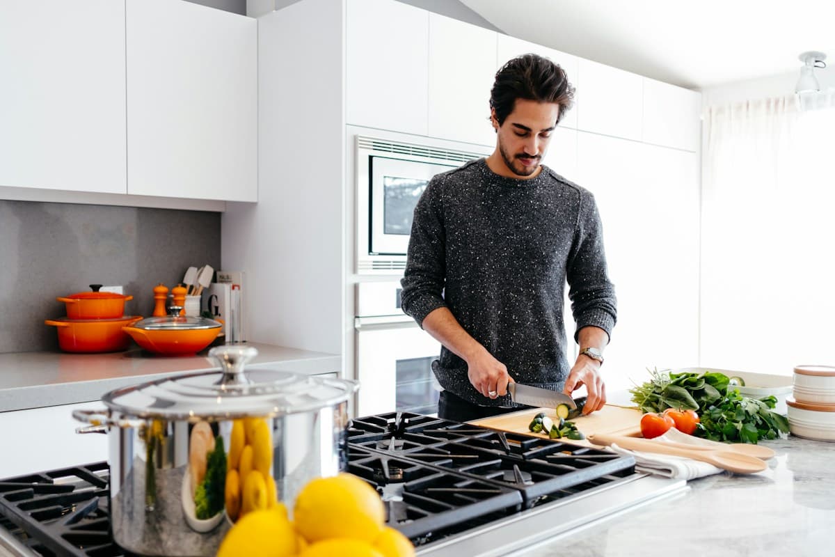 Hands chopping vegetables on a cutting board