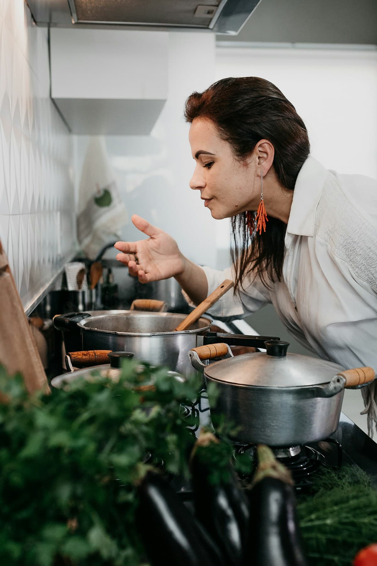 A cook tasting food from the pot